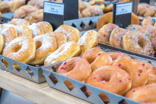 Variety of tasty looking dounuts for sale at bkery shop.