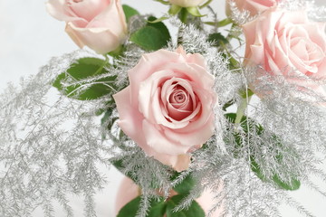 Flowers background.  beautiful pink roses and silver leaves bouqut in a vase top view on white backgrop. Floral card. 