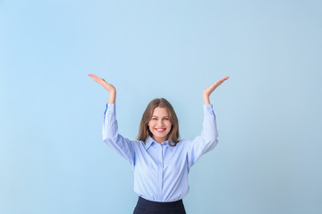 Young businesswoman on color background