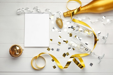 Christmas composition with decor and champagne on wooden background