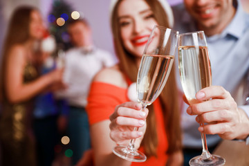 Friends having fun and drinking champagne at New Year party