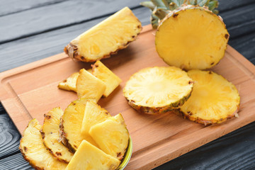Fresh cut pineapple on wooden background