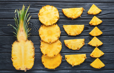 Fresh cut pineapple on wooden background