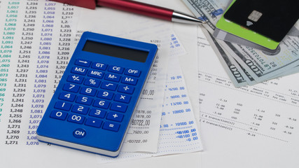 Payment card and calculator on top of supermarket receipt. Shopping and payment concept