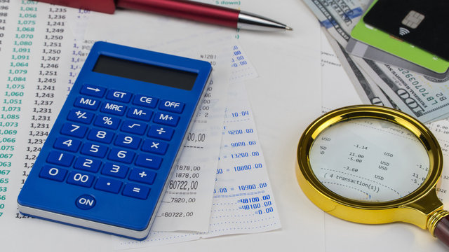 Calculator and us dollars on top of supermarket receipt. Shopping and payment concept