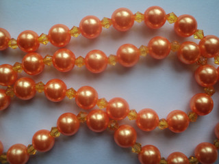 Shiny orange pearls pattern with white background
