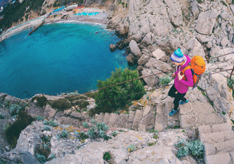 A woman descends the steps from the top of the mountain.