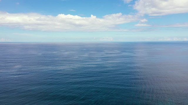 Seascape by day. Sea and sky with clouds in calm weather.