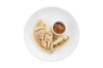 two thin pancakes with berry jam on the side isolated on white background