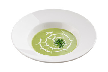 broccoli and green peas cream soup on white plate isolated on white background