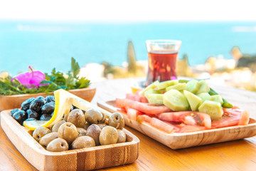 Breakfast on the beach at hotel or resort by the sea in summer season. Holiday and vacation breakfast image.Traditional Turkish or Greek breakfast at bodrum town beach in Turkey or Greece