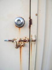 rusted yellow steel door handle and latch 