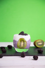 black chia pudding with blackberry and kiwi