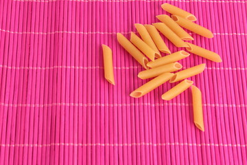 pasta raw feathers on colorful background