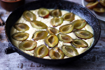 Homemade plum pie. Cooking plum cake. Selective focus. Macro.