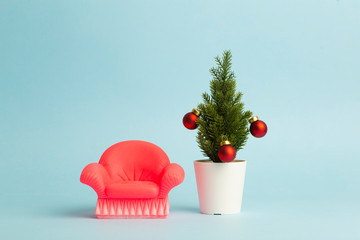 New Year tree with a toy chair. New Year and Christmas comfort concept