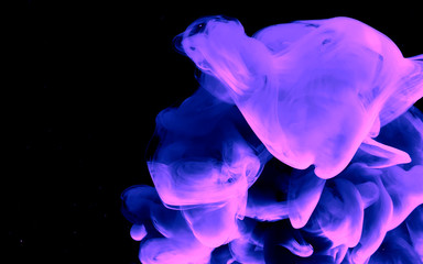 Watercolor ink in water. Violet space abstract background.
