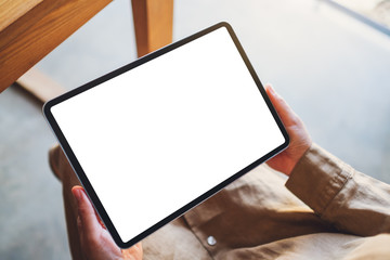 Mockup image of a woman holding black tablet pc with blank white screen