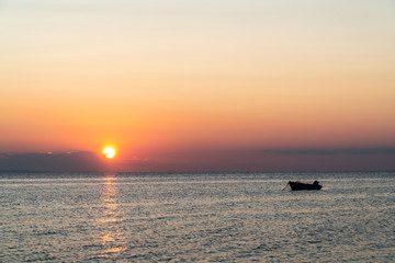 Boat in the middle of the sea during sunset