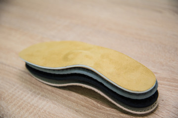samples of different orthopedic insoles. insole with a variety of coating