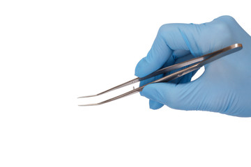 Dentist's hand with tweezers on white isolated background..
