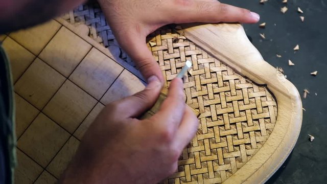 wood carving master carves the Board for the game