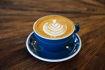 Cup of coffee latte art with coffee shop.