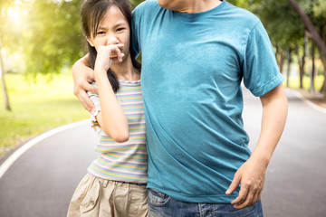 Man was hugging her daughter while her child girl can smell the armpit smelly or the body odor foul from her father with closing her nose,feel stinks,asian male people smell and sweat from hot weather