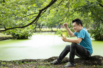 Happy man hold mobile phone and check mail,screams with joy,feel excited,surprised after looking for a job,male people reading good news message on phone from the company has received his to work