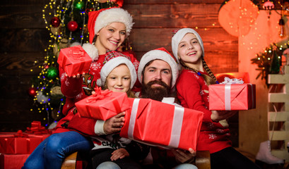 Parents and children opening christmas gifts. Father Santa claus and mother little daughters christmas tree background. Christmas tradition. Family bonding activities. Christmas joy. Happy holidays