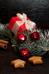 Christmas dark background with festive decoration, cookies, gingerbread and spruce branches