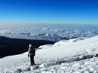 Papier Peint photo autocollant Kilimandjaro hikers on the ridge ascend mount kilimanjaro the tallest peak in africa.