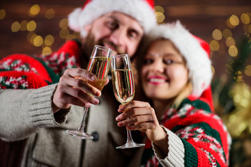 Drinks for adults. Happy new year. Merry christmas. Celebrating christmas together. Home party. Sparkling wine glasses close up. Festive atmosphere. Couple in love enjoy christmas holiday celebration