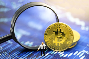 Miniature people : Businessman with Magnifying glass of bitcoin graph chart ,bitcoin Stock Market Analysis