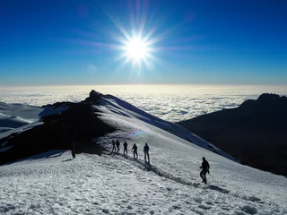 Wall murals Kilimanjaro hikers on the ridge ascend mount kilimanjaro the tallest peak in africa.