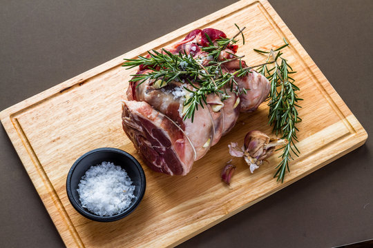 Raw rolled and tied Herdwick Sheep lamb joint prepared with garlic, rosemary and sea salt.