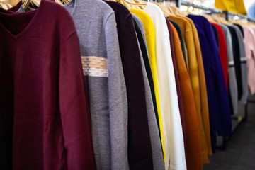 Long sleeved t-shirt many colours hanging on the rack,comfortable clothes and cheap,variety of...