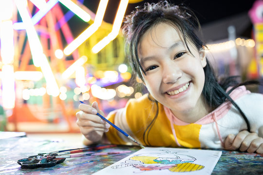 Smiling asian female people study and learning the art,happy teenage girl with palette and paintbrush to painting watercolor on canvas,painting a picture,drawing,concept art creativity, development