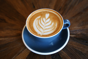 Cup of coffee latte art with coffee shop.