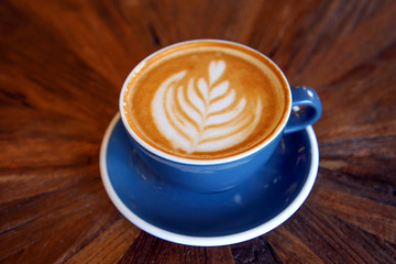 Cup of coffee latte art with coffee shop.