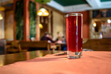 Moss-berry mors on a cafe table on blurred background © Andrey Nikitin