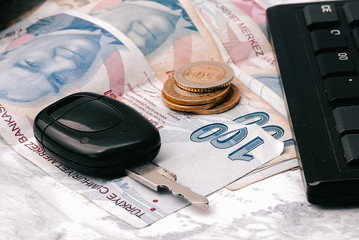 Key from the car and the calculator on money.(tax)