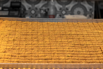 Kanafeh, a traditional Arabic dessert, special dough, with goat cheese, pistachio, almonds, nuts, butter, and honey. Old City, Jerusalem, Israel.
