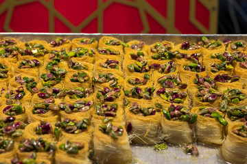Kanafeh, a traditional Arabic dessert, special dough, with goat cheese, pistachio, almonds, nuts, butter, and honey. Old City, Jerusalem, Israel.