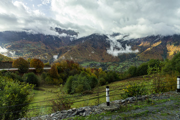 Fototapeta na wymiar Mountain slopes covered with forests and low thunderclouds in Svaneti in the mountainous part of Georgia