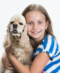 Pretty smiling girl with american spaniel posing in studio