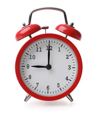Red alarm clock set at nine isolaten over white background