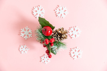 a sprig of Holly on pink background