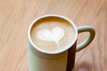 Hot coffee art latte on wooden table