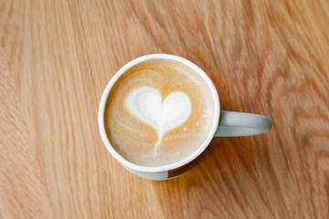 Hot coffee art latte on wooden table